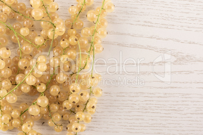 Fresh white currant berries on grey wood