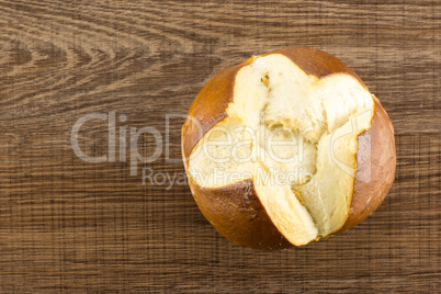 Fresh Bavarian bread bun on brown wood