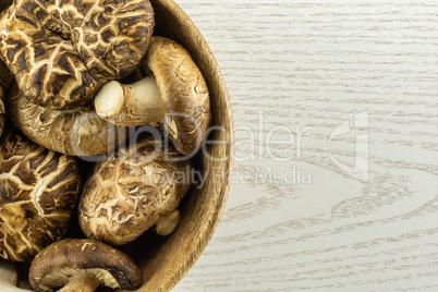 Fresh raw shitake mushroom on grey wood