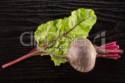 Fresh raw red beetroot on black wood