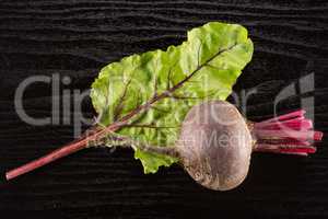 Fresh raw red beetroot on black wood