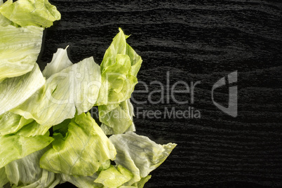 Fresh Raw Iceberg Lettuce on black wood