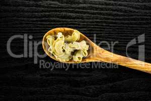 Fresh raw paste Creste di Gallo on black wood