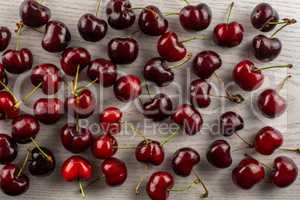Fresh raw sweet red cherry on grey wood