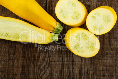 Fresh Raw yellow zucchini on brown wood