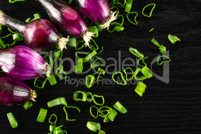 Fresh Raw green spring onion on black wood