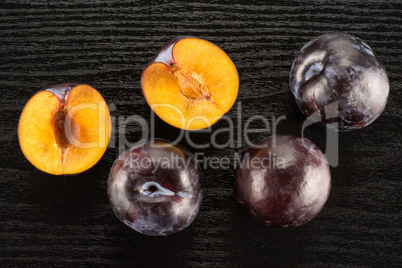 Red Blue Plums on black wood