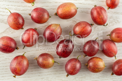 Fresh raw red gooseberry on grey wood