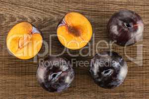 Red Blue Plums on brown wood