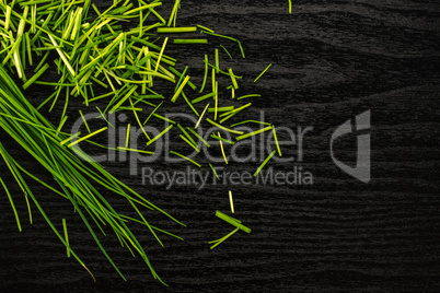 Fresh Raw Chives on black wood