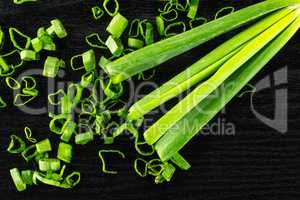 Fresh Raw green spring onion on black wood