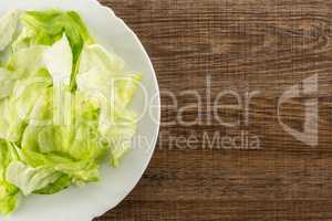 Fresh Raw Iceberg Lettuce on brown wood