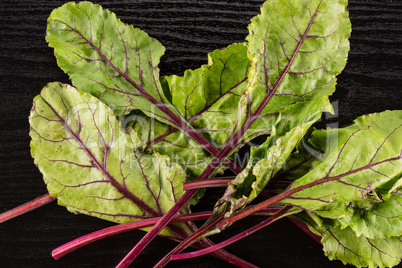 Fresh raw red beetroot on black wood