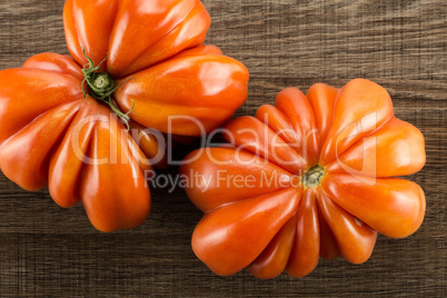 Fresh Raw Beef Tomato on brown wood