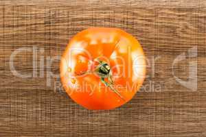 Fresh raw Tomato (La Parcela variety) on brown wood