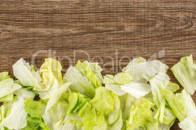 Fresh Raw Iceberg Lettuce on brown wood