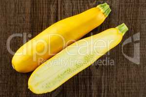 Fresh Raw yellow zucchini on brown wood