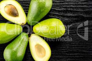 fresh Raw smooth avocado on black wood
