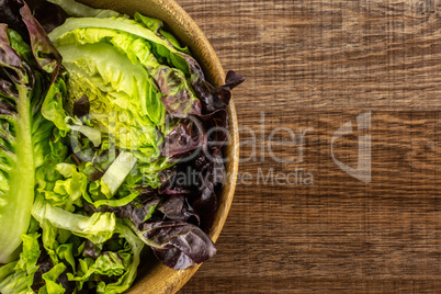 Fresh raw lettuce red little gem on brown wood