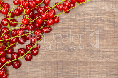 Fresh raw red currant on brown wood