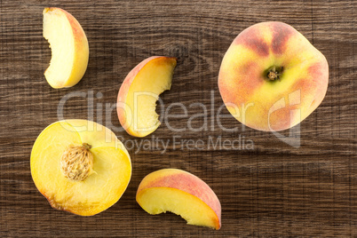 Fresh Raw yellow peach on brown wood