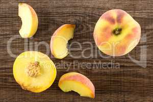 Fresh Raw yellow peach on brown wood