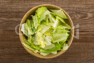 Fresh Raw Iceberg Lettuce on brown wood