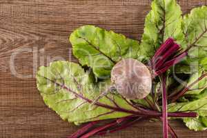 Fresh raw red beetroot on brown wood