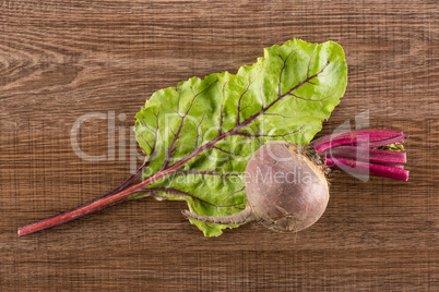 Fresh raw red beetroot on brown wood