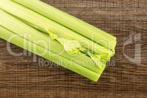 Fresh Celery isolated on brown wood