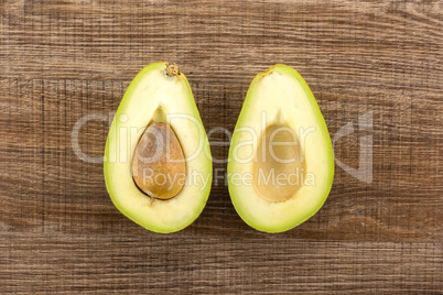 fresh Raw smooth avocado on brown wood