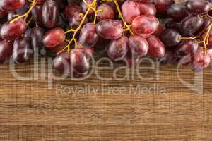 Raw fresh red globe grape on brown wood
