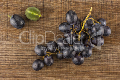 Fresh Black Wine Grapes on brown wood