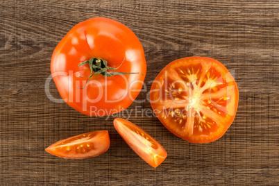 Fresh raw Tomato (La Parcela variety) on brown wood