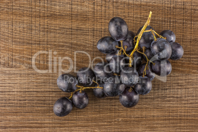 Fresh Black Wine Grapes on brown wood