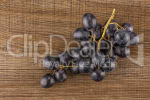 Fresh Black Wine Grapes on brown wood