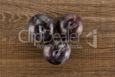Red Blue Plums on brown wood