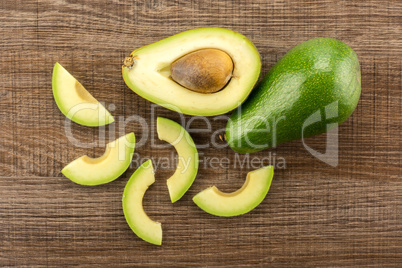 fresh Raw smooth avocado on brown wood