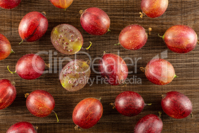 Fresh raw red gooseberry on brown wood