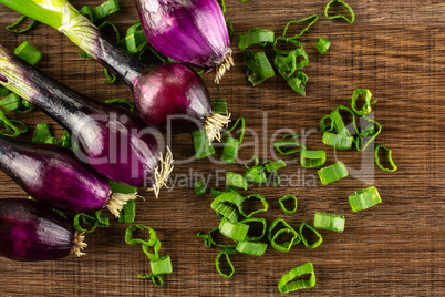 Fresh Raw green spring onion on brown wood