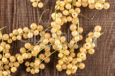 Fresh white currant berries on brown wood