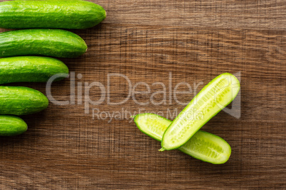 Fresh raw mini cucumber on brown wood