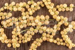 Fresh white currant berries on brown wood