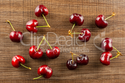 Fresh raw sweet red cherry on brown wood