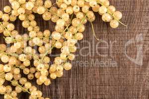 Fresh white currant berries on brown wood