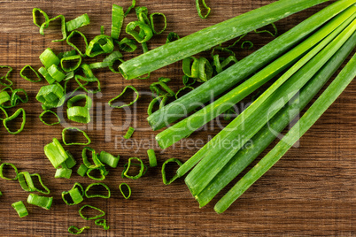 Fresh Raw green spring onion on brown wood