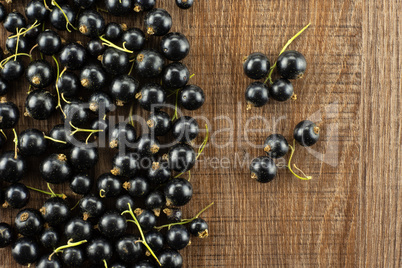 Fresh Raw Black Currant berry on brown wood
