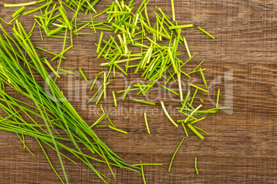 Fresh Raw Chives on brown wood