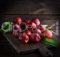 red ripe peaches nectarine on a brown wooden board