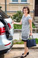 Woman next to car on the street